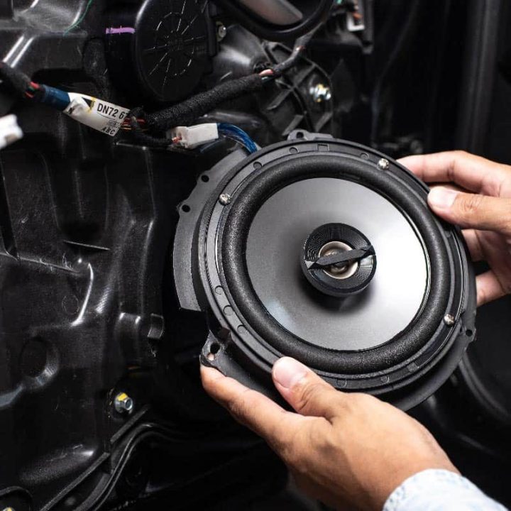 Technician-installing-the-car-speaker-to-the-car-door
